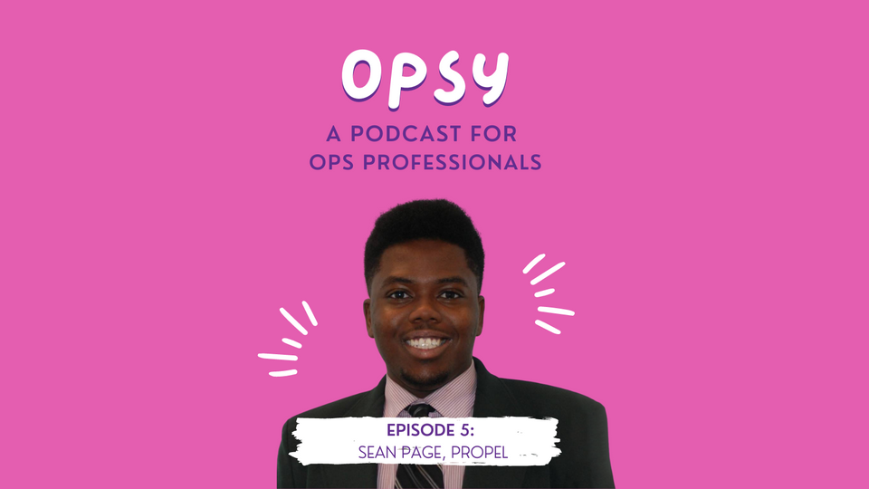 A smiling man in a suit is imposed on a pink background with a headline that reads, Opsy: a podcast for ops professionals